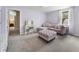 A bedroom with a purple sectional, dressing table, and access to an en-suite bathroom at 1491 Black Hickory Pl, Norcross, GA 30093