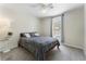 Cozy bedroom featuring plush carpeting, a ceiling fan, and a comfortable bed beneath a window with blue curtains at 1491 Black Hickory Pl, Norcross, GA 30093
