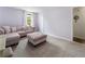 Bedroom featuring a comfortable purple sectional, ottoman and large windows at 1491 Black Hickory Pl, Norcross, GA 30093