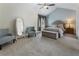 Comfortable bedroom with a vaulted ceiling, carpeted floor, bench, and a comfortable sitting area at 1491 Black Hickory Pl, Norcross, GA 30093
