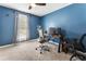 Bedroom with blue walls and carpeted floors, a ceiling fan, and a window bringing natural light into the room at 1491 Black Hickory Pl, Norcross, GA 30093