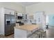 Bright kitchen featuring stainless steel appliances, white cabinets, and a center island at 1491 Black Hickory Pl, Norcross, GA 30093