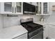 Close-up of the kitchen featuring stainless steel appliances and marble countertops at 1491 Black Hickory Pl, Norcross, GA 30093