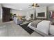 Open concept living room with modern furniture, a large TV, and a bedroom space in the background at 1491 Black Hickory Pl, Norcross, GA 30093