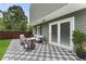 Outdoor patio with tile flooring, comfortable seating, and double doors leading inside at 1491 Black Hickory Pl, Norcross, GA 30093