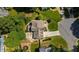 Aerial view of a home with a landscaped yard, stone patio, and a circular driveway at 230 Bristol Stone Ct, Johns Creek, GA 30005