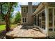 Outdoor patio with stone and backyard featuring a chair, a tree, and a screened porch at 230 Bristol Stone Ct, Johns Creek, GA 30005