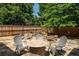Backyard with stone patio, waterfall, and seating area at 230 Bristol Stone Ct, Johns Creek, GA 30005