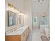 Elegant bathroom featuring double vanity, marble countertop, glass shower, and soaking tub at 230 Bristol Stone Ct, Johns Creek, GA 30005