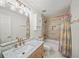 Bright bathroom with vanity, marble countertops, and modern gold fixtures at 230 Bristol Stone Ct, Johns Creek, GA 30005