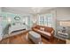 Stylish bedroom with a leather couch, hardwood floors, and an abundance of natural light at 230 Bristol Stone Ct, Johns Creek, GA 30005