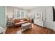Stylish bedroom with a leather couch, hardwood floors, and an abundance of natural light at 230 Bristol Stone Ct, Johns Creek, GA 30005