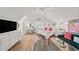 Spacious bedroom featuring vaulted ceilings, a ceiling fan, hardwood floors, and a plush green couch at 230 Bristol Stone Ct, Johns Creek, GA 30005