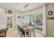 Inviting dining room with a modern light fixture and sliding glass doors that let in natural light at 230 Bristol Stone Ct, Johns Creek, GA 30005