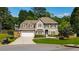 Charming two-story home with a well-manicured lawn, two-car garage, and inviting front porch with a welcoming entrance at 230 Bristol Stone Ct, Johns Creek, GA 30005