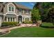 Beautiful home exterior with flagstone patio, manicured lawn, and lush landscaping at 230 Bristol Stone Ct, Johns Creek, GA 30005