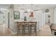 A brightly lit kitchen featuring a stylish island with barstool seating and modern pendant lighting at 230 Bristol Stone Ct, Johns Creek, GA 30005