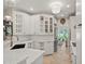 Elegant kitchen with white cabinets, quartz countertops, and open layout at 230 Bristol Stone Ct, Johns Creek, GA 30005