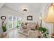 Cozy living room with neutral colors, shuttered windows, and stylish décor at 230 Bristol Stone Ct, Johns Creek, GA 30005