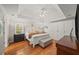 Spacious main bedroom with hardwood floors, ceiling fan, and custom built-in wardrobe at 230 Bristol Stone Ct, Johns Creek, GA 30005