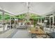 Bright sunroom with plenty of seating, natural light, and a view of the backyard at 230 Bristol Stone Ct, Johns Creek, GA 30005