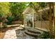 Stone path leading to a well-lit sunroom, perfect for enjoying nature indoors at 230 Bristol Stone Ct, Johns Creek, GA 30005