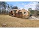 Back exterior elevation of home with multilevel deck and long driveway at 3032 Ross Rd, Snellville, GA 30039