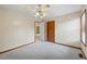This cozy bedroom features soft carpet, a ceiling fan, closet, and exterior window view at 3032 Ross Rd, Snellville, GA 30039