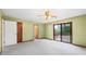 This bedroom features a ceiling fan, carpet, closet, and a sliding door to the deck at 3032 Ross Rd, Snellville, GA 30039