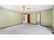 Spacious bedroom with a walk in closet, ceiling fan, carpet and bathroom access at 3032 Ross Rd, Snellville, GA 30039