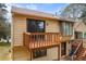 View of the home with a wood deck and wood siding at 3032 Ross Rd, Snellville, GA 30039