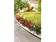 Inviting front yard featuring a well-manicured lawn and vibrant flower beds at 3032 Ross Rd, Snellville, GA 30039