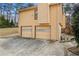 Double garage doors on home with long driveway, side yard and exterior elevation at 3032 Ross Rd, Snellville, GA 30039