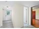 Hallway featuring modern flooring, a door to the backyard, and a bathroom entrance at 3032 Ross Rd, Snellville, GA 30039