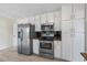 Functional kitchen with stainless steel appliances, granite countertops, and ample cabinet space for storage at 3032 Ross Rd, Snellville, GA 30039
