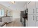 Well-equipped kitchen featuring stainless steel appliances, granite countertops, and ample white cabinetry at 3032 Ross Rd, Snellville, GA 30039