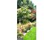 A colorful garden with rose bushes and flowering trees surrounding a home at 3032 Ross Rd, Snellville, GA 30039