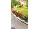 Sidewalk lined with vibrant rose bushes and decorative white gravel, showcasing a well-maintained front yard at 3032 Ross Rd, Snellville, GA 30039