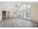 Spacious living room with stone fireplace, large windows, and vaulted ceilings, offering plenty of natural light and openness at 3032 Ross Rd, Snellville, GA 30039