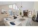 Bright living room featuring vaulted ceilings, large windows, fireplace, and modern decor creating a cozy atmosphere at 3032 Ross Rd, Snellville, GA 30039