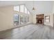 Spacious living room with stone fireplace, large windows, and vaulted ceilings, offering plenty of natural light and openness at 3032 Ross Rd, Snellville, GA 30039