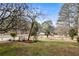A partial view of the front yard with a road, trees, and bushes at 3032 Ross Rd, Snellville, GA 30039