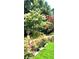 Beautifully landscaped yard with manicured lawn and colorful flower bushes at 3032 Ross Rd, Snellville, GA 30039
