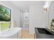 Luxurious bathroom features a standalone tub and glass shower with elegant fixtures at 4002 Lindsey Dr, Decatur, GA 30035