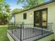 Cozy patio with decorative iron railing and glass doors leading indoors at 4002 Lindsey Dr, Decatur, GA 30035