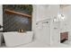 Luxurious bathroom with a freestanding tub and herringbone tile accents at 434 Marietta St Nw # 401, Atlanta, GA 30313