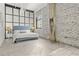 Cozy bedroom features exposed brick, large windows, and a comfortable bed at 434 Marietta St Nw # 401, Atlanta, GA 30313