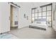 Modern bedroom with exposed brick, large windows, and trendy sliding door at 434 Marietta St Nw # 401, Atlanta, GA 30313