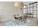 Dining room with seating for six, exposed brick wall, and modern decor at 434 Marietta St Nw # 401, Atlanta, GA 30313