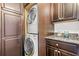 Functional laundry room with stacked washer/dryer, granite countertop and storage cabinets at 434 Marietta St Nw # 401, Atlanta, GA 30313